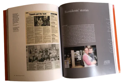 Open book with residents' stories clippings.